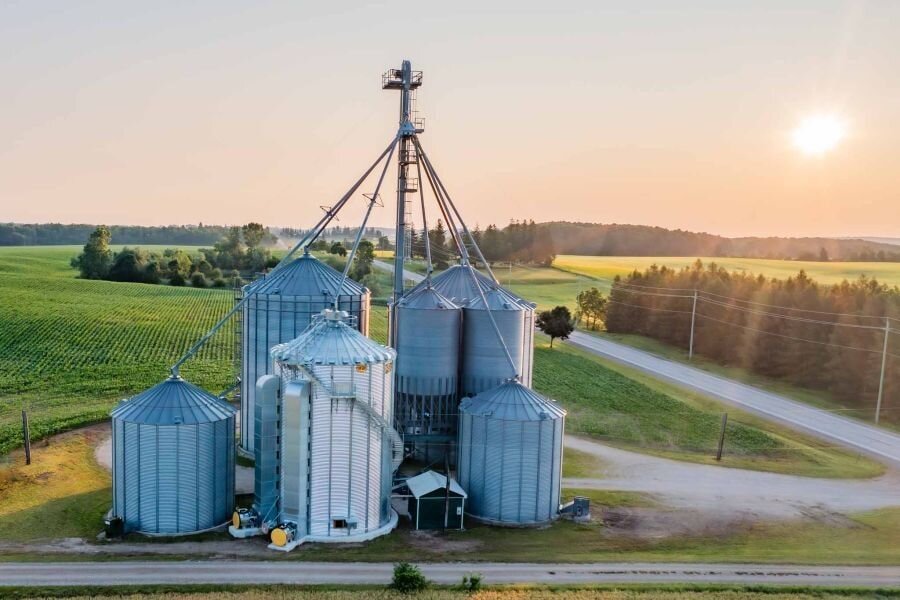 Grain storage bins at sunset with rural Ontario landscape